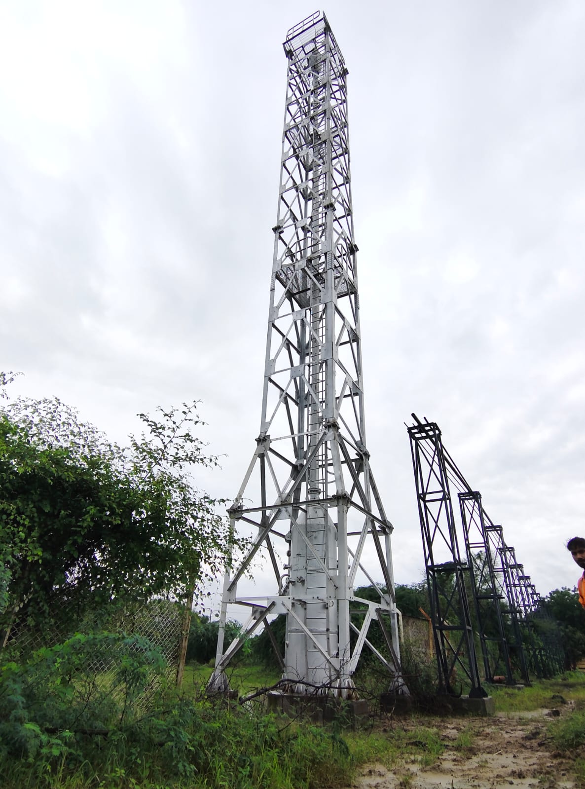 Vertical structural lattice flare stack tower assembled with pipeline trestle bridge