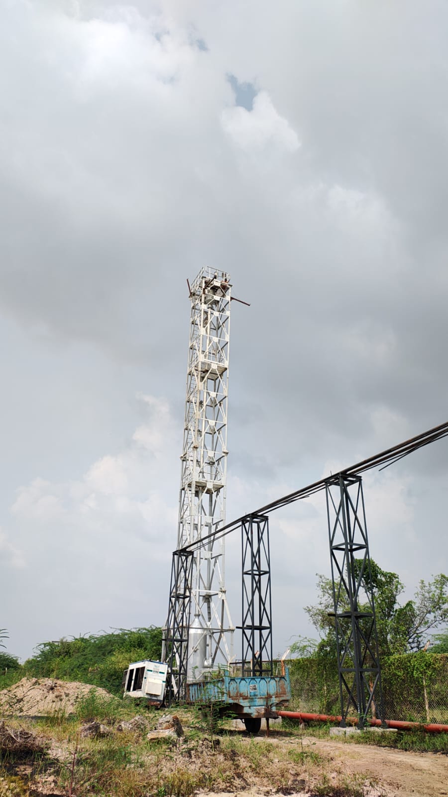 ONGC vertical lattice flare stack tower and overhead pipeline gantry trestles