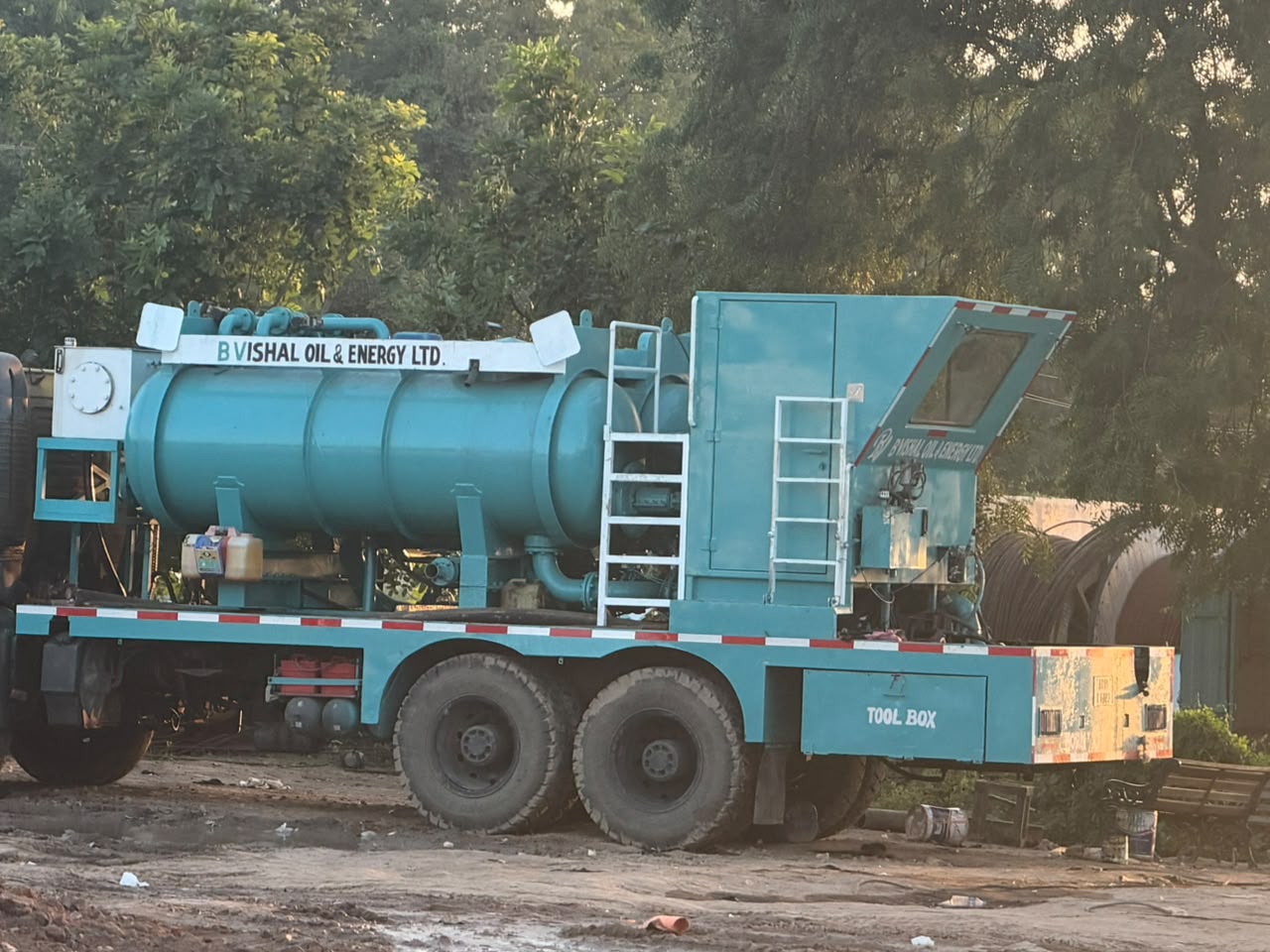 Custom fabricated truck-mounted cylindrical liquid pressure tank with suction manifolds